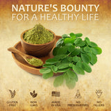 Moringa leaf capsules alongside moringa powder in a bowl, emphasizing natural health benefits.